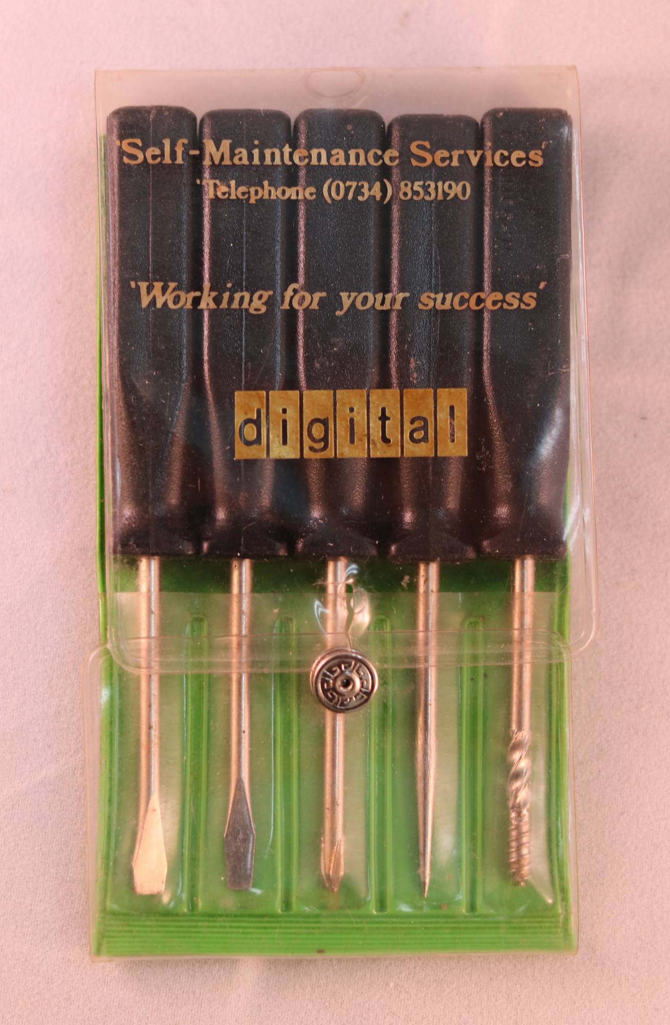 green and black plastic case with metal tools