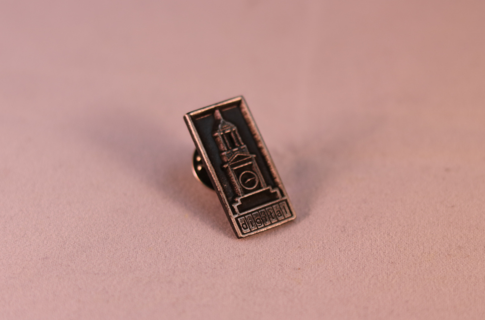 black and gold clock tower pin
